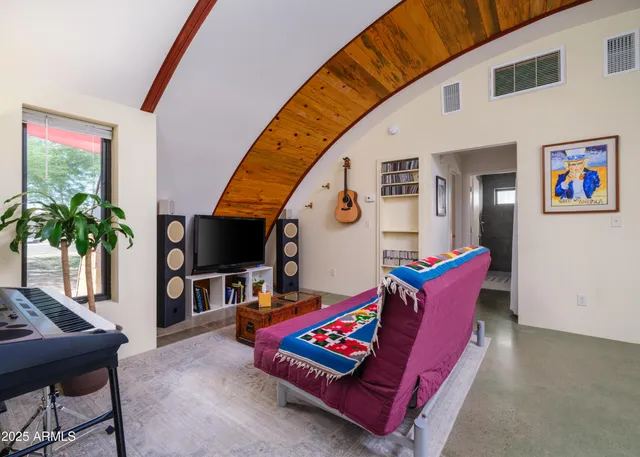 a bed room with furniture and window