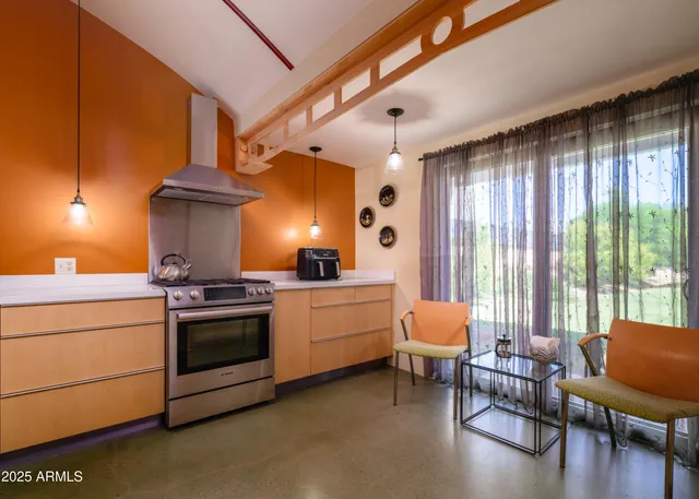 a kitchen with stainless steel appliances a refrigerator and a table