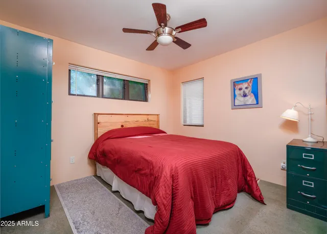a view of a backyard with table and chairs under an umbrella
