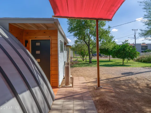 a view of a patio with table and chairs with wooden floor and fence