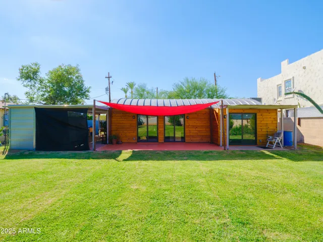 a view of an house with swimming pool and a yard