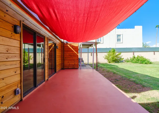 a balcony with red umbrella
