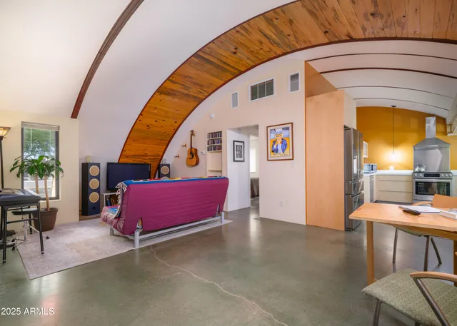 a living room with furniture and a book shelf
