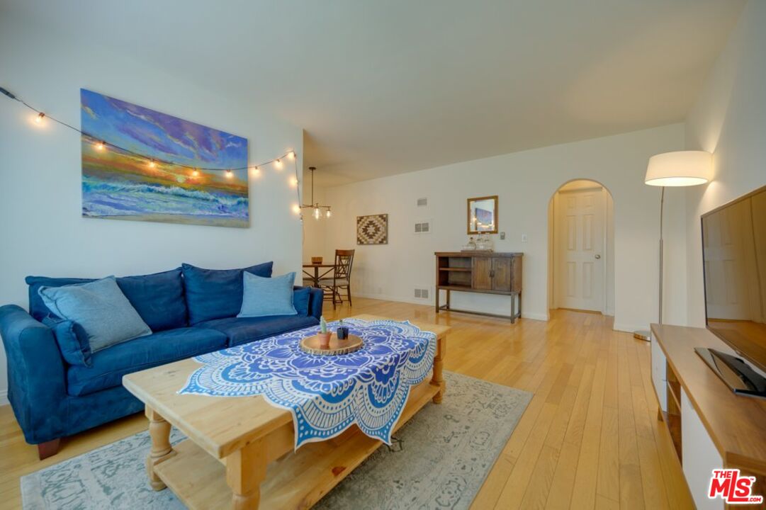 1918 11th Street, Unit F Santa Monica, CA 90404 - Photo 1 of 14 a living room with furniture and a flat screen tv
