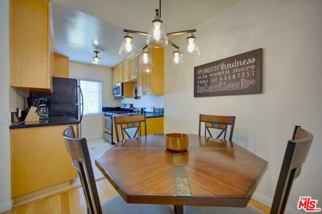 1918 11th Street, Unit F Santa Monica, CA 90404 - Photo 7 of 14 a view of a dining room with furniture and a chandelier
