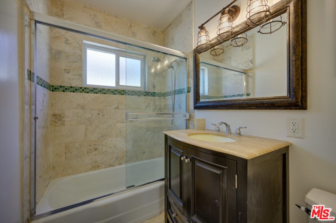 1918 11th Street, Unit F Santa Monica, CA 90404 - Photo 9 of 14 a bathroom with a sink and a mirror