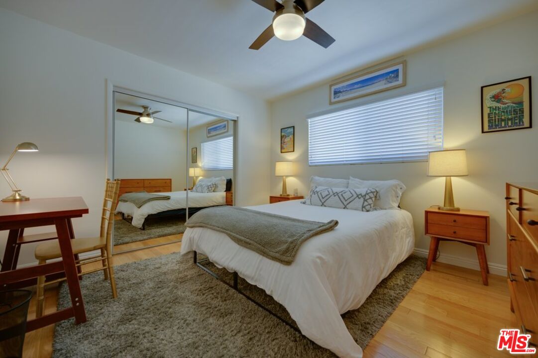 1918 11th Street, Unit F Santa Monica, CA 90404 - Photo 10 of 14 a bedroom with bed and a chandelier