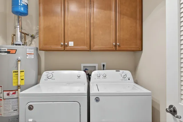 a bedroom with a bed a chandelier and a window