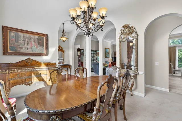 a dining room with furniture and chandelier