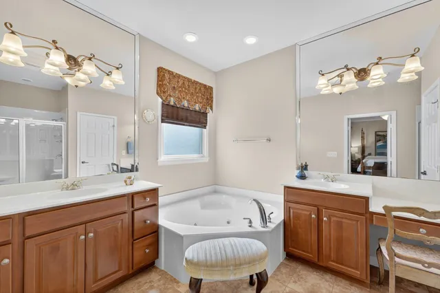 a bedroom with a large bed and mirror