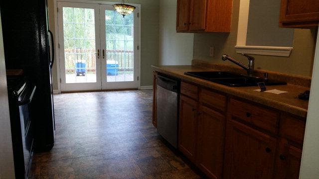 250 Autumn Ridge Court Gray, GA 31032 - Photo 2 of 12 a kitchen with granite countertop a stove a sink and a cabinets