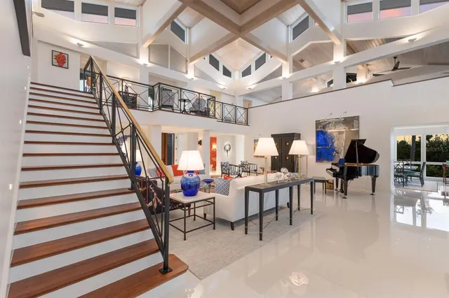 a living room with furniture a flat screen tv and a window