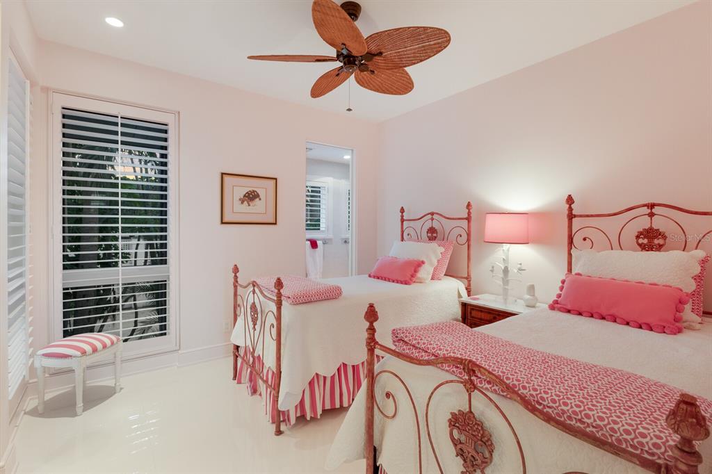 641 Boca Bay Drive Boca Grande, FL 33921 - Photo 42 of 98 a bedroom with a bed and a chandelier