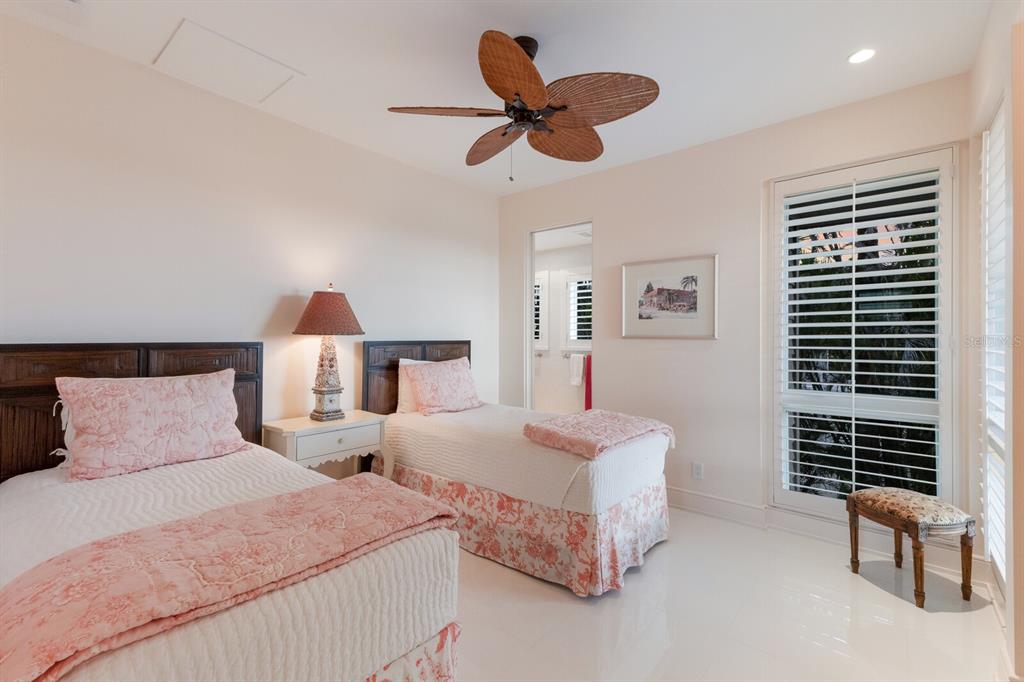 641 Boca Bay Drive Boca Grande, FL 33921 - Photo 47 of 98 a bedroom with two beds and painted walls