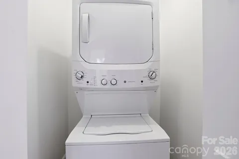 a utility room with dryer and white door