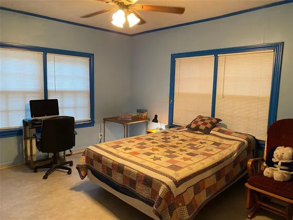 a bed sitting in a bedroom next to a window