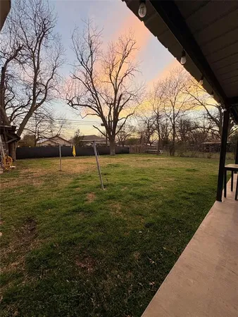 a view of a field with an trees