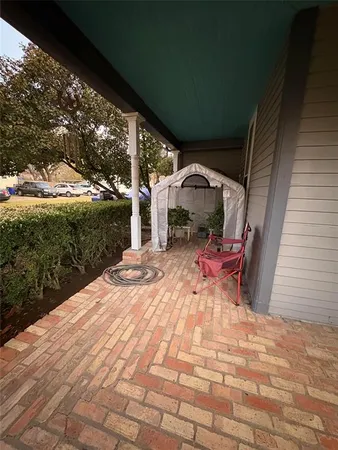 a view of a patio with table and chairs with wooden floor and fence