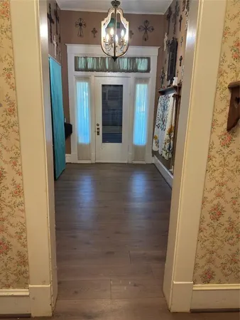 a view of an entryway with wooden floor