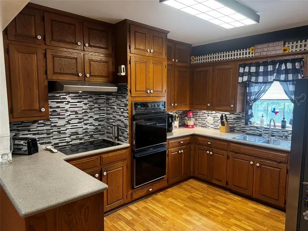a kitchen with a sink and wooden cabinets