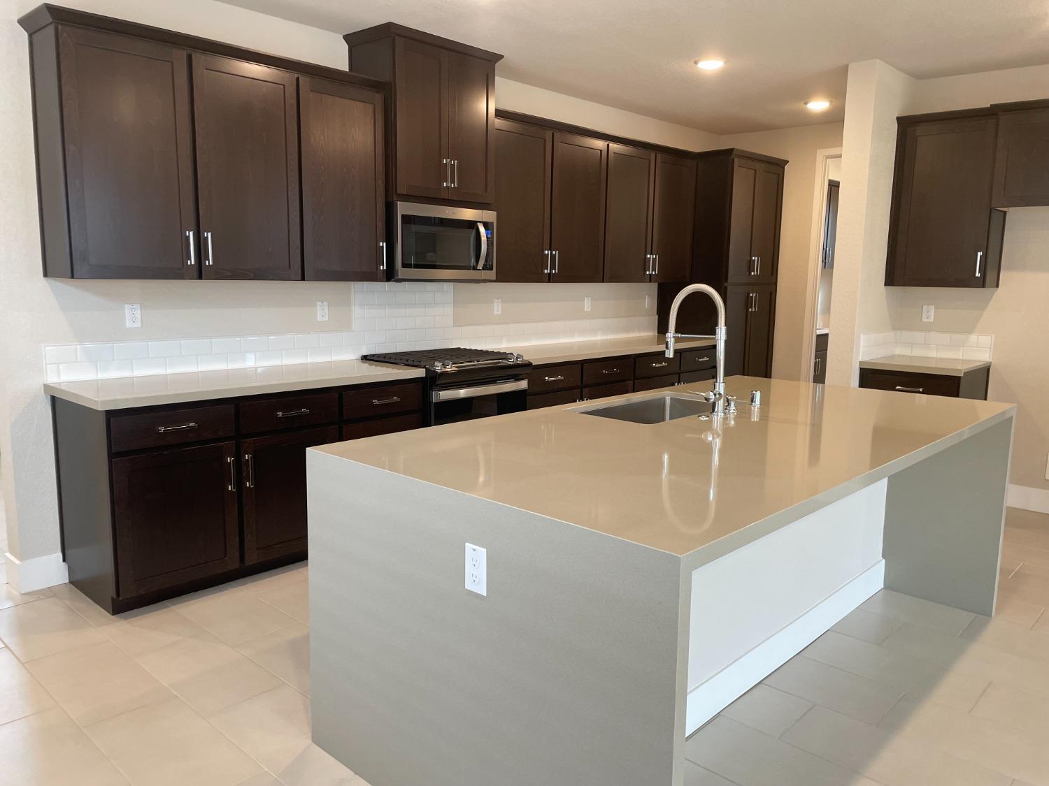 3068 Poas Way Rancho Cordova, CA 95742 - Photo 2 of 10 a kitchen with stainless steel appliances granite countertop a sink and a refrigerator