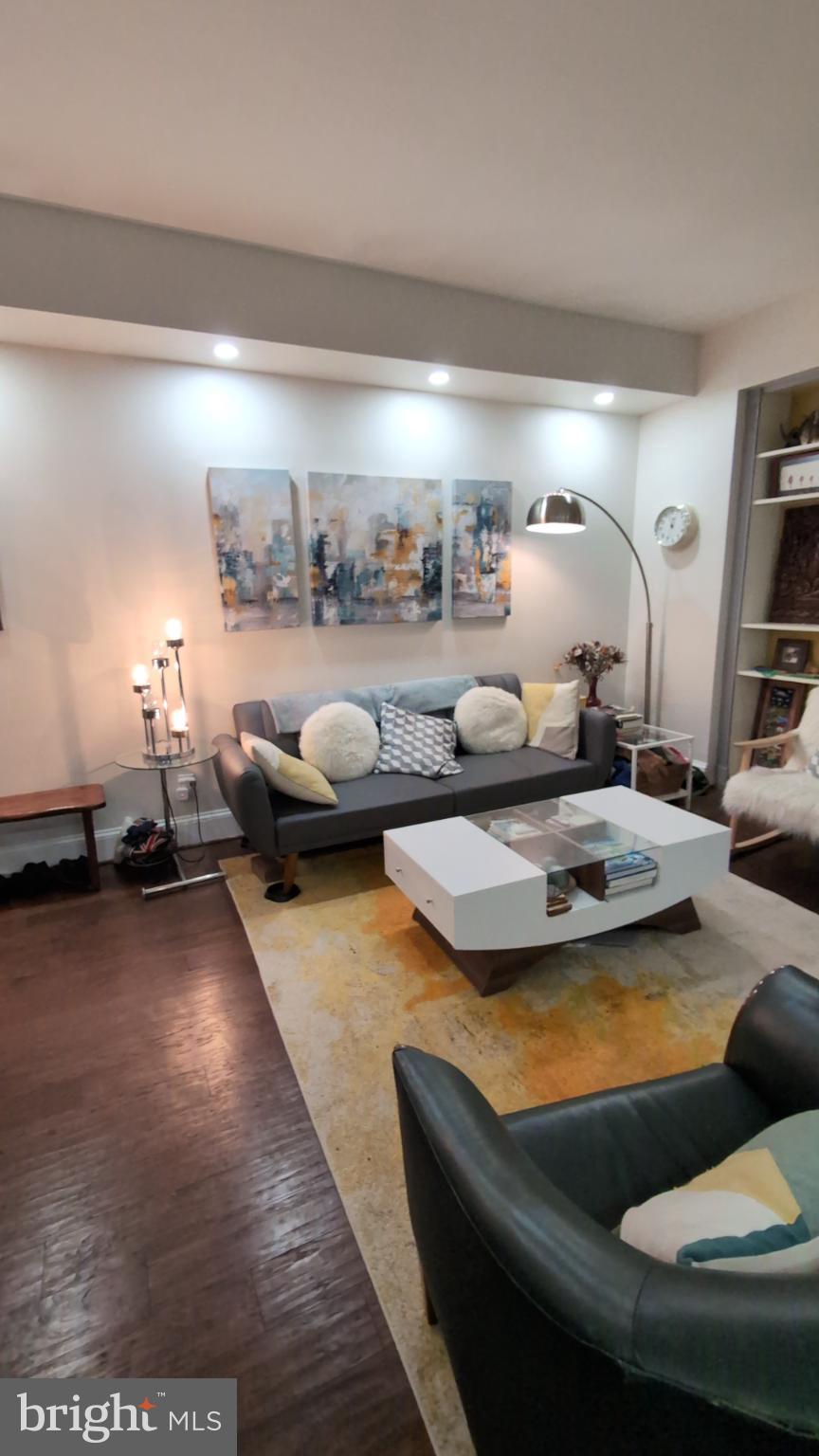 2127 California Street Northwest, Unit 102 Washington, DC 20008 - Photo 8 of 10 a living room with furniture and a wooden floor