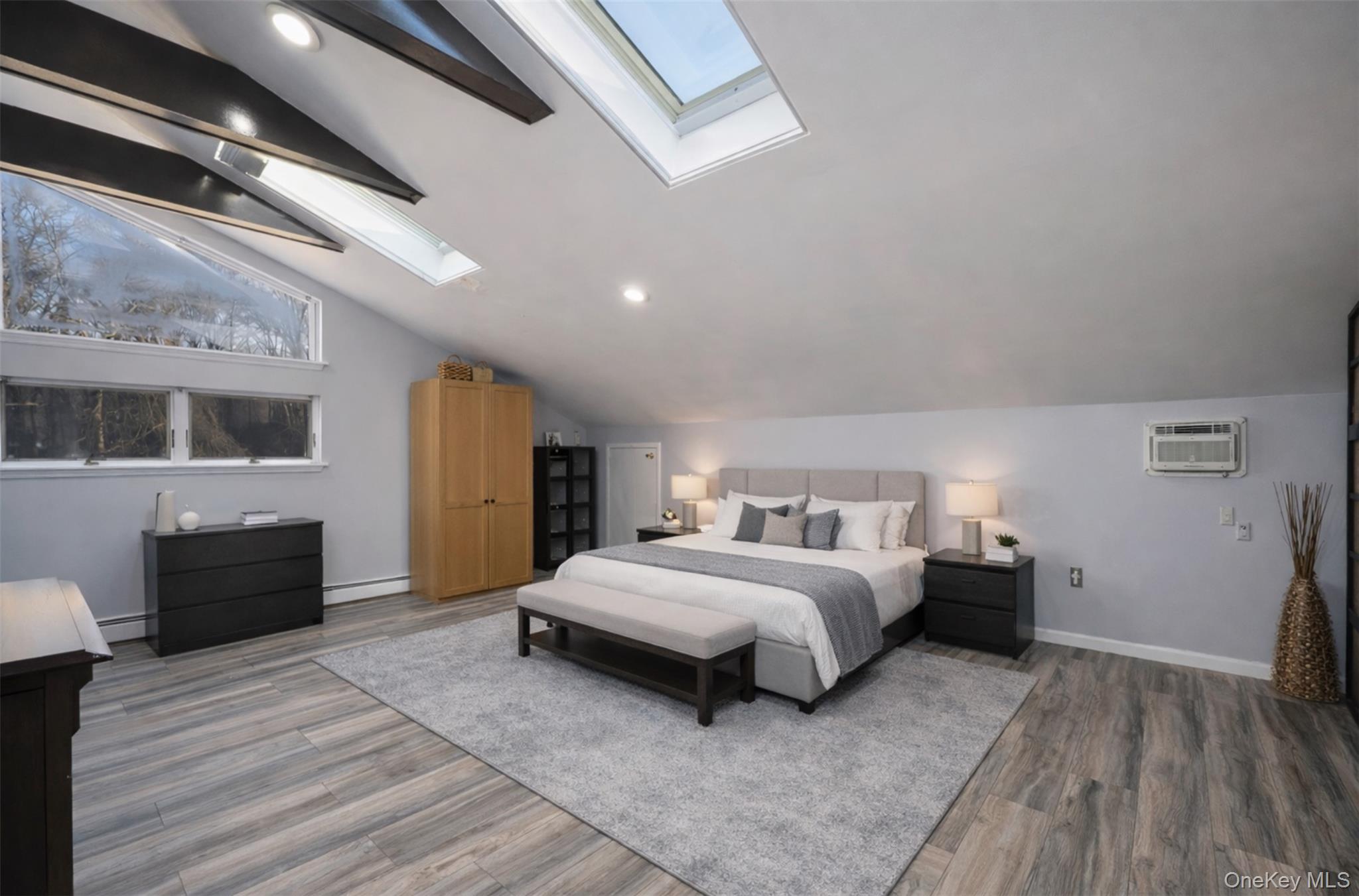 27 Spice Hill Road Croton-on-Hudson, NY 10520 - Photo 13 of 20 a spacious bedroom with a bed a dresser and wooden floor