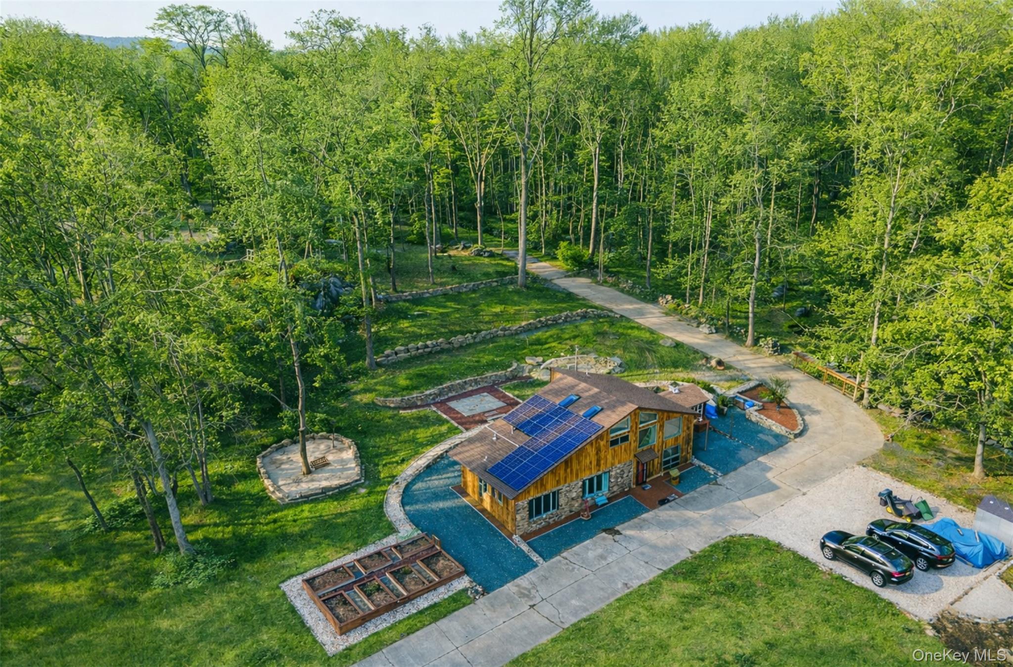 27 Spice Hill Road Croton-on-Hudson, NY 10520 - Photo 20 of 20 a backyard of a house with lots of green space and fountain