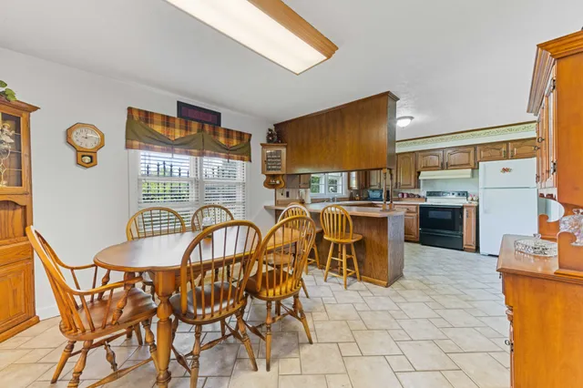 a dining room with furniture and a floor to ceiling window
