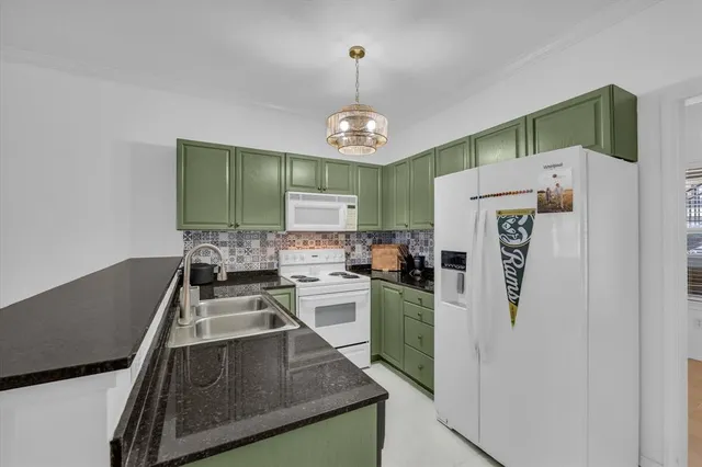 a kitchen with stainless steel appliances granite countertop a refrigerator a sink dishwasher a stove and a refrigerator