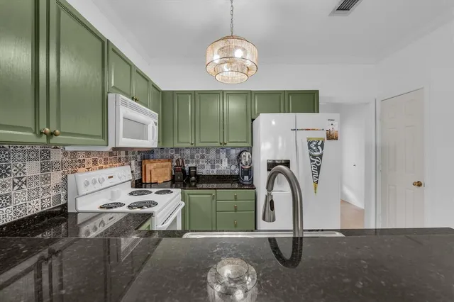 a kitchen with a refrigerator a stove top oven a sink and dishwasher