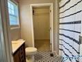 70 Covington Rdg Drive Jacksonville, AL 36265 - Photo 39 of 42 a bathroom with a granite countertop sink and a mirror