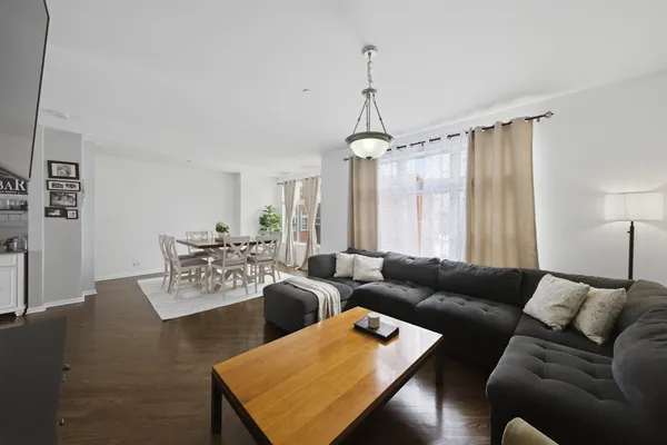 a living room with furniture wooden floor and a window