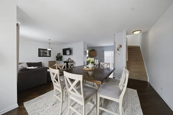 a dining room with furniture and wooden floor