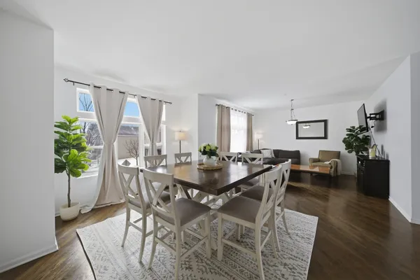 a view of a dining room with furniture and wooden floor
