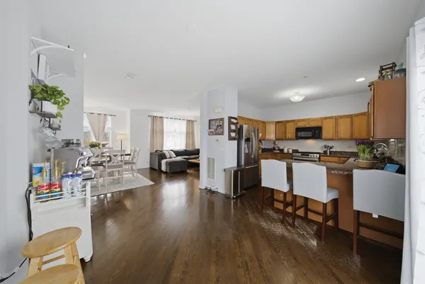 a living room with furniture and kitchen view
