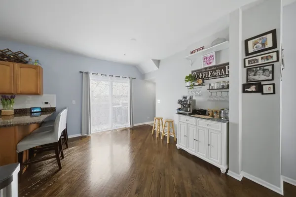 a kitchen with stainless steel appliances granite countertop a stove cabinets and wooden floor