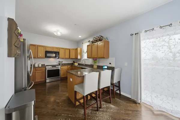 a kitchen with a sink cabinets and wooden floor