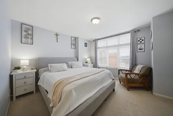 a bed room with a bed and a chair