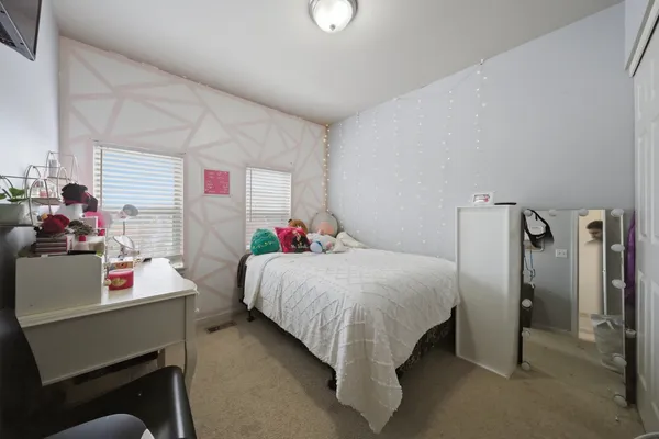 a bedroom with a bed and a table