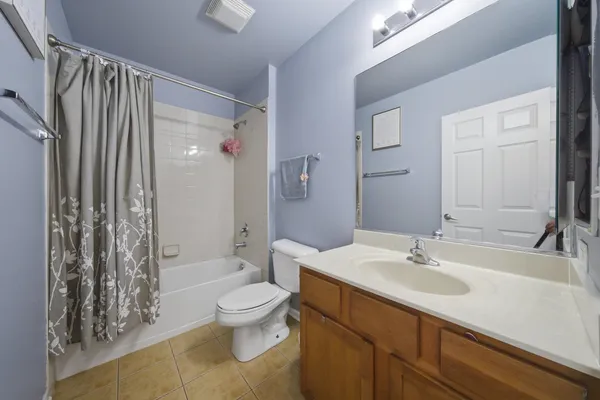 a bathroom with a sink toilet a mirror and shower
