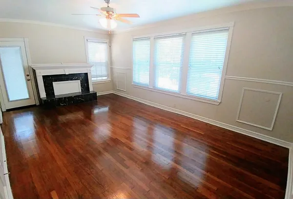 wooden floor in an empty room with a window