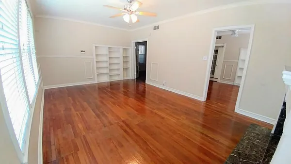 wooden floor in an empty room with a window
