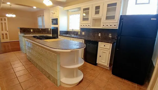 a kitchen with a sink and a stove top oven