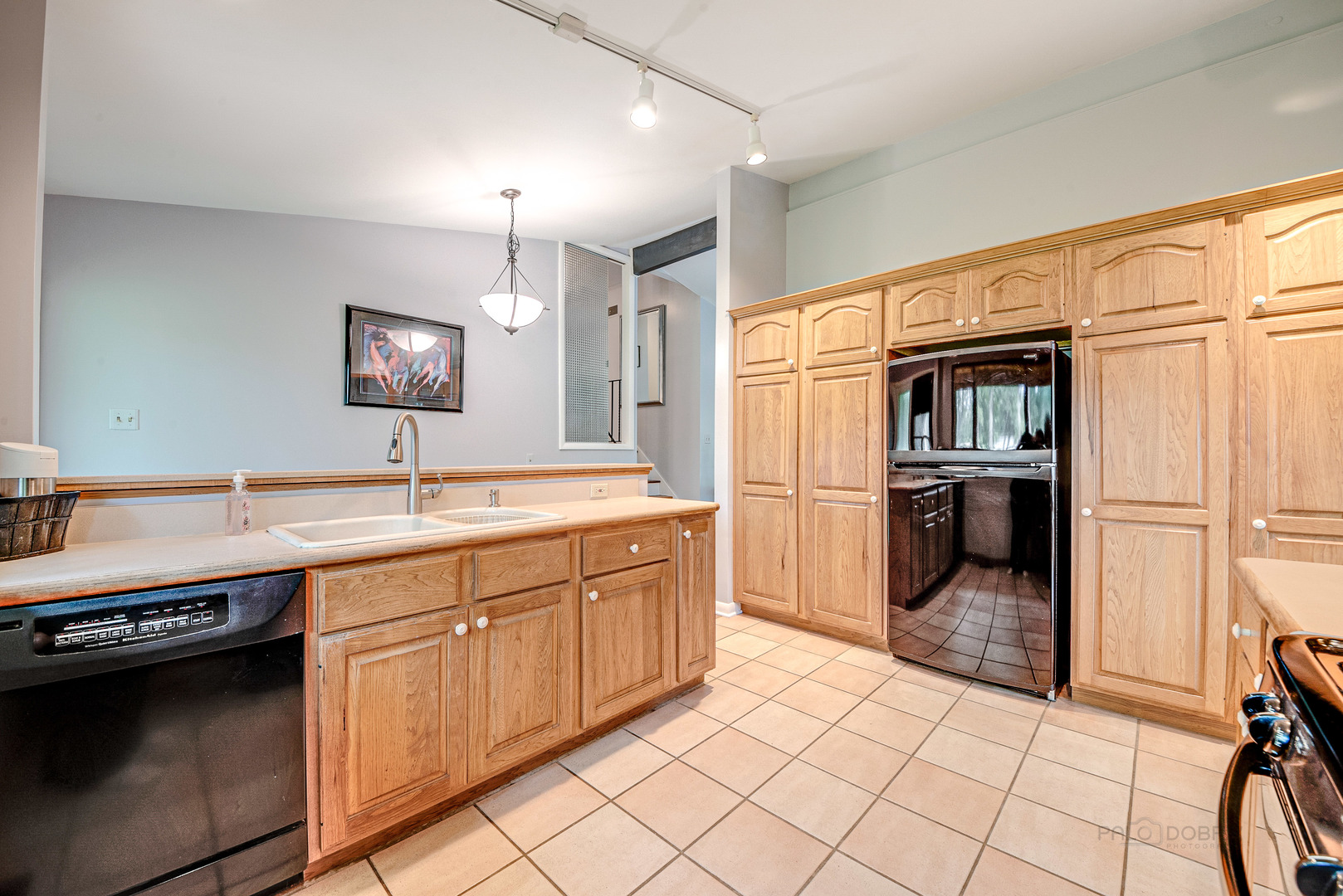 703 Hickory Road Woodstock, IL 60098 - Photo 11 of 33 a kitchen with stainless steel appliances a sink and a refrigerator