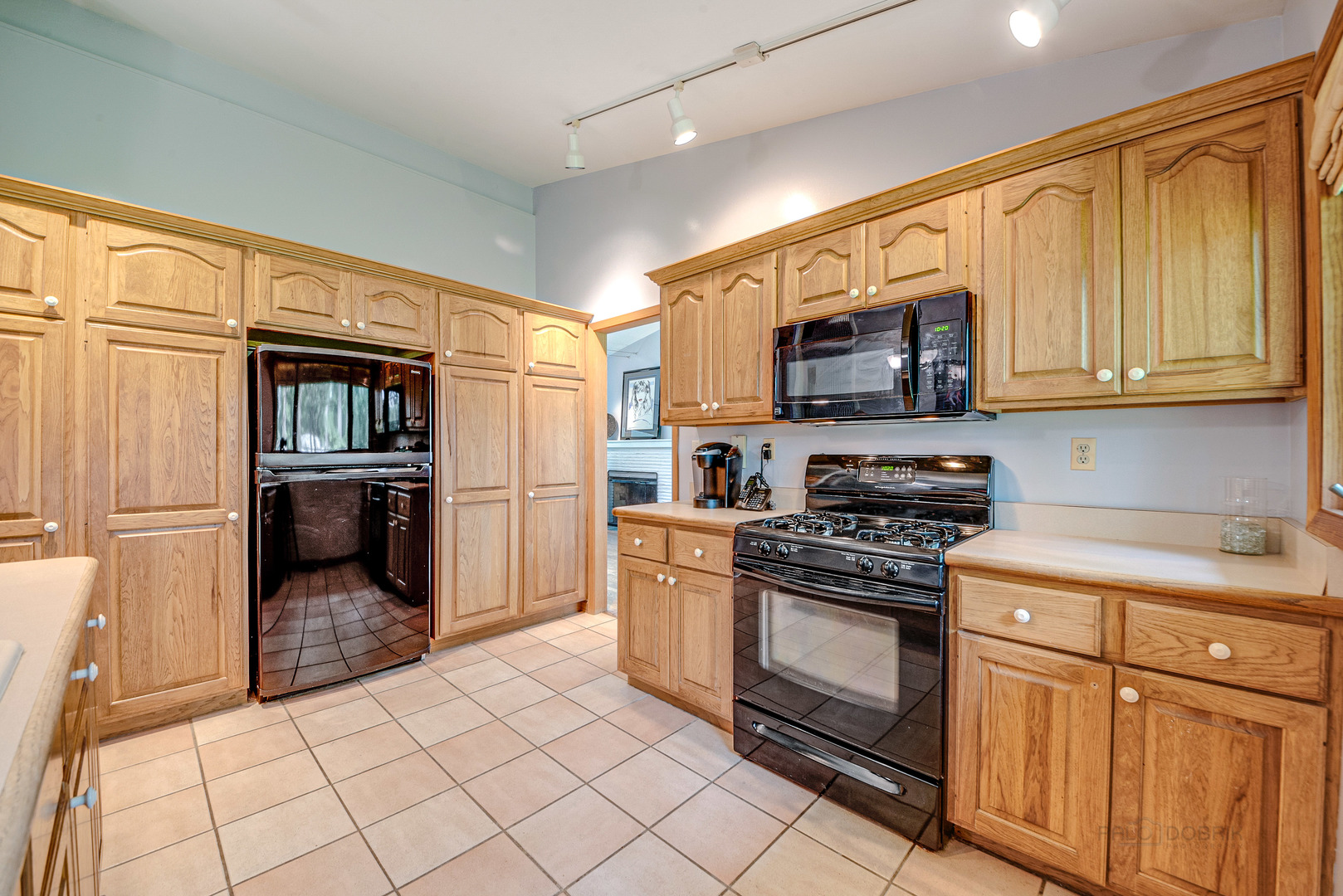 703 Hickory Road Woodstock, IL 60098 - Photo 12 of 33 a kitchen with a stove top oven and cabinets