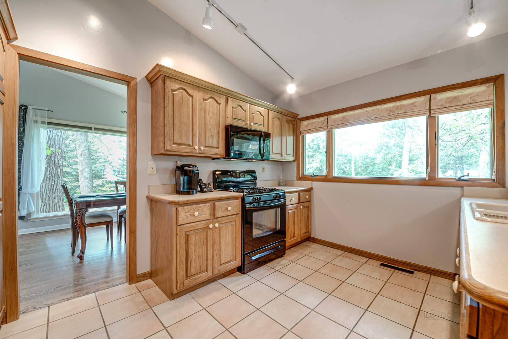 703 Hickory Road Woodstock, IL 60098 - Photo 13 of 33 a kitchen with granite countertop a stove a sink dishwasher and a refrigerator
