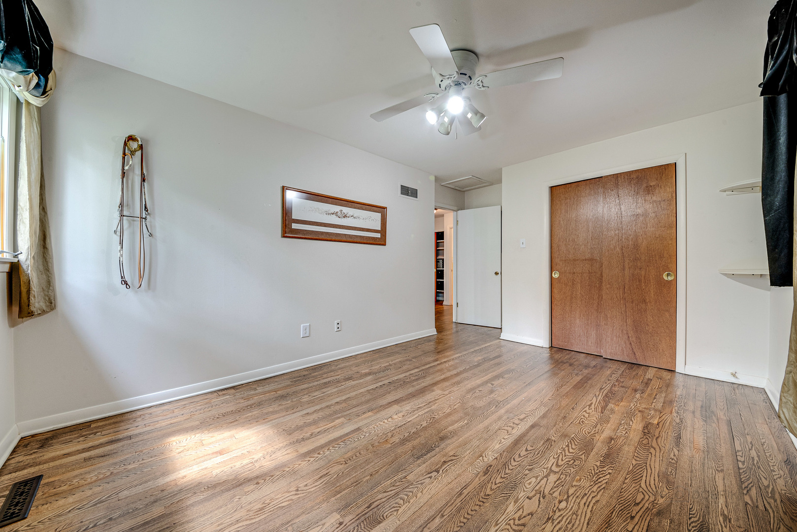 703 Hickory Road Woodstock, IL 60098 - Photo 18 of 33 a view of an empty room with wooden floor