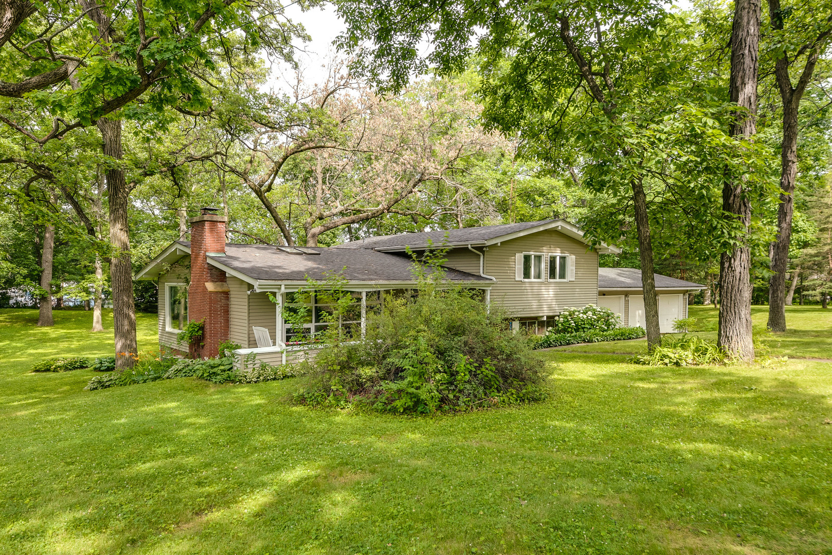703 Hickory Road Woodstock, IL 60098 - Photo 2 of 33 a front view of a house with a yard