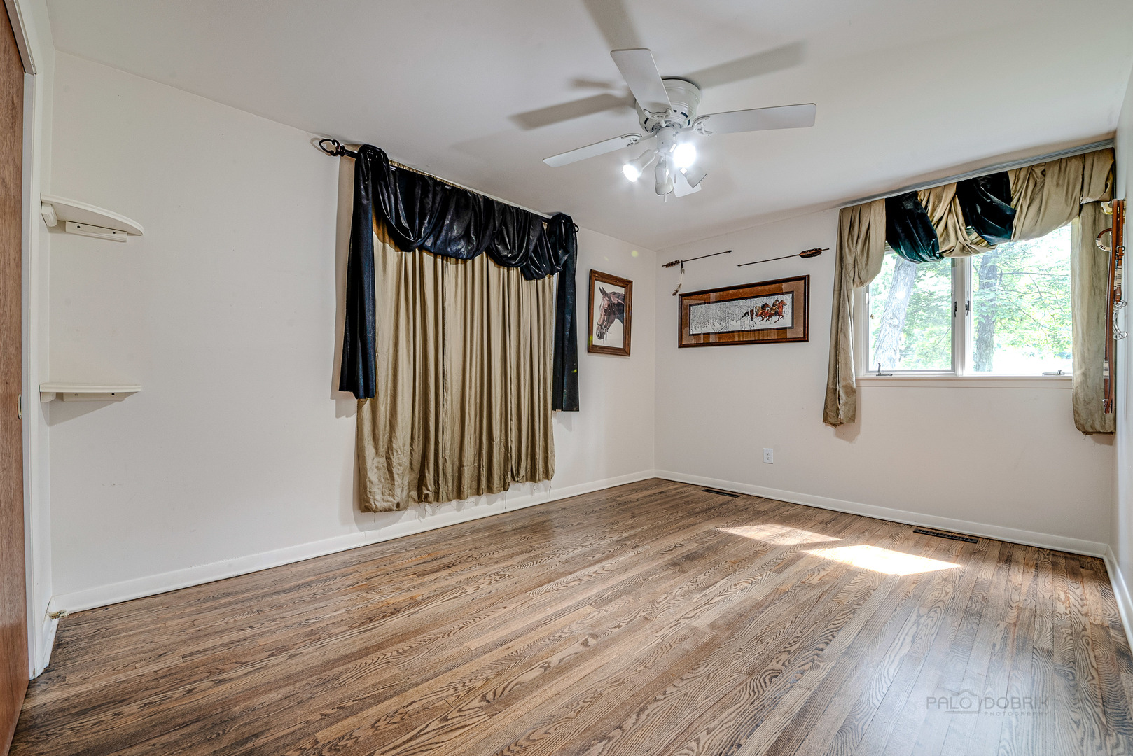 703 Hickory Road Woodstock, IL 60098 - Photo 21 of 33 wooden floor in an empty room with a window